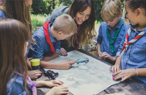 a group of beavers using a magnifying glass.