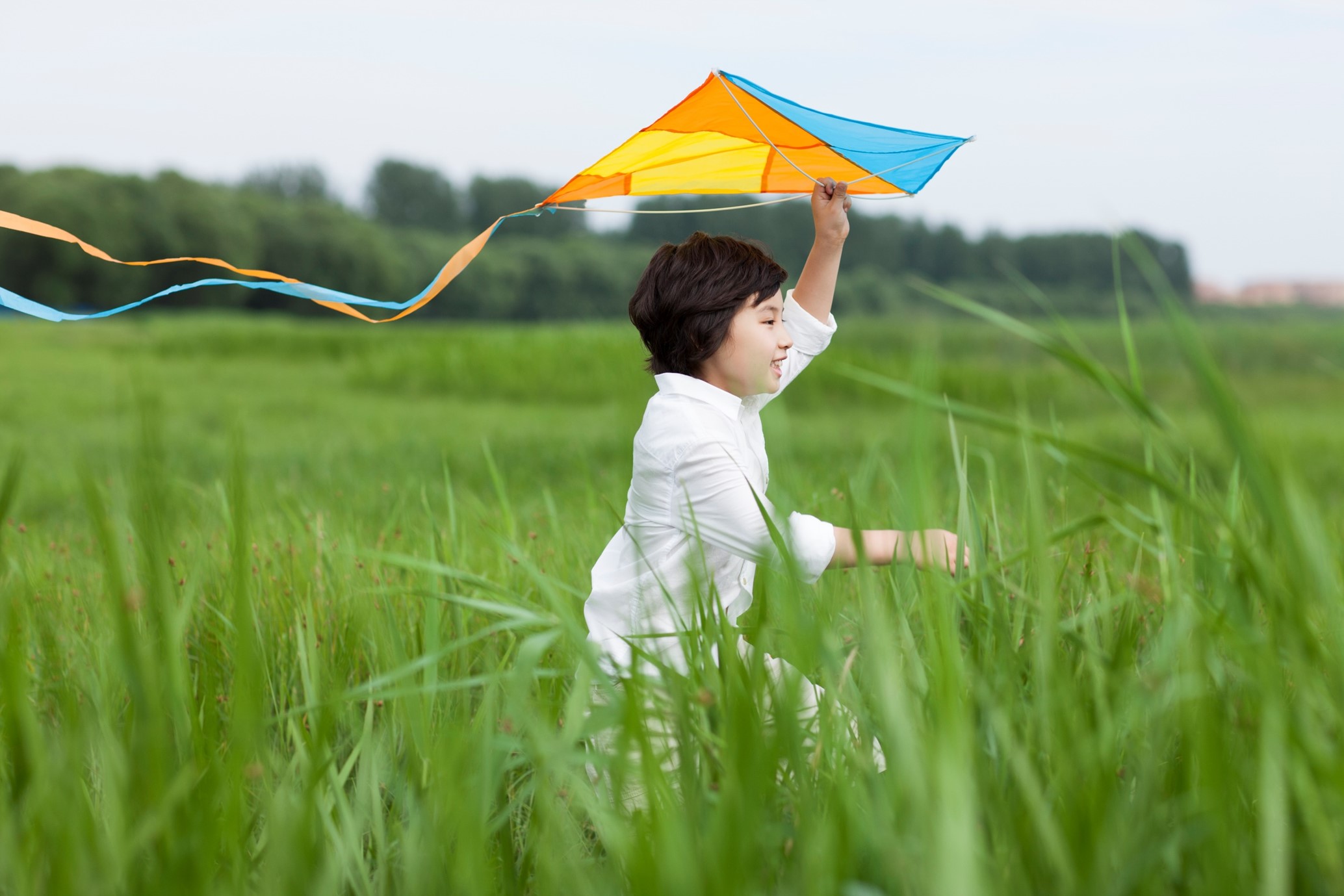 a budding scout flying a kite.